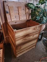 Open wooden box showing interior and hinged lid