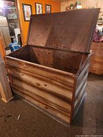 lid open showing interior of wooden storage chest