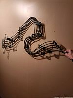 Full view of black metal wall art mounted on wall