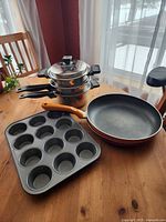 Overview of all cookware including saucepans, frying pan and muffin pan
