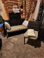 Loveseat and chair with cushions and pillows