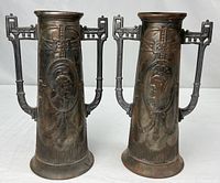 Both matching copper vases front view