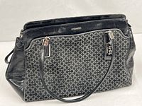 Front view of Coach Kimberly Carryall showing jacquard pattern, leather trim and handles