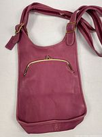Full view of pink leather Coach sling bag front