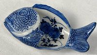 Top view of fish-shaped dish showing blue and white glaze and floral interior