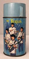 Front view showing Beatles band members on blue thermos with cup lid