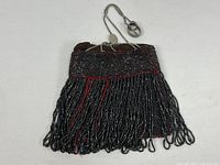 Front view of beaded purse showing fringe and overall shape