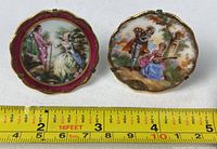 Both Limoges brooch pins front view with measuring tape