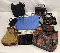 Group of eight handbags and umbrella