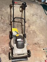 Full view of Craftsman electric mower showing body, wheels, handle, rear flap