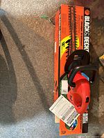 Hedge trimmer on original box with manual visible