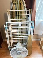 All four items: drying rack collapsed, ironing board, sleeve board, tabletop fan