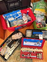 Overview of tools in red tote, socket set case, tarpaulin