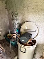 Trash can, lid, watering can, trellis, pots, tomato cage