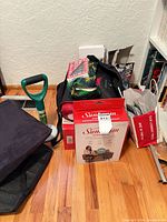 Full lot showing boxed Sunbeam heated wrap, EZ-RISE tool, and assorted items