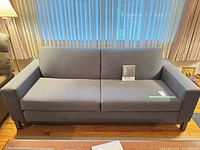 Front view of gray herringbone sofa with two seat cushions