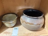 Two planters side by side on shelf