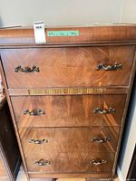 Front view showing four drawers and hardware