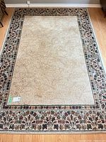 Full view of rectangular area rug showing overall pattern and wear