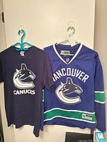 Front view of both jersey and T-shirt hanging
