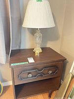 Nightstand with lamp on top showing overall appearance