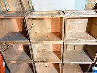 Front view of stacked 3×3 plywood cubes showing overall condition