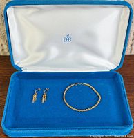 Bracelet and earrings inside blue case
