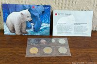 Front view of polar bear presentation card with coin set below