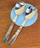 Full view of spoon and fork on wood surface