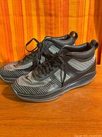 Full view of both Nike LeBron X JE Icon QS sneakers side by side