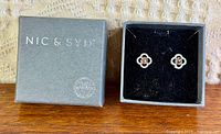 Closed Nic & Syd box beside open box showing earrings