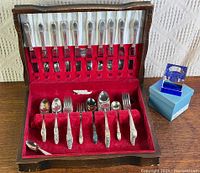 Open flatware chest showing knives, forks, spoons