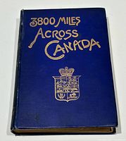 Front cover showing blue cloth boards with gilt title and crest