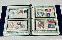 Binder open showing four Vatican FDCs with cachets and stamps