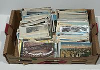 Top view of produce tray box filled with sorted stacks of postcards.