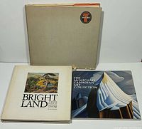 front view of three art books, covers and slipcase visible
