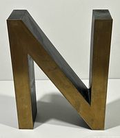 Front perspective showing brass face and black side of letter N
