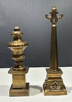 Both brass finials side by side showing relative sizes and designs