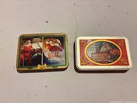 Two Coca-Cola holiday tins, lids visible
