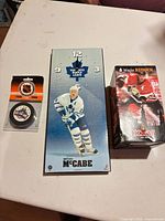 All three items: clock, puck in blister, bobblehead boxed