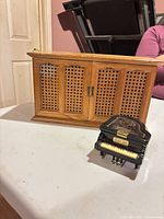 Cabinet closed with piano music box in front