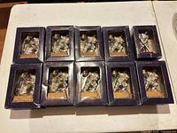 Ten boxed hockey player figurines displayed in two rows on table