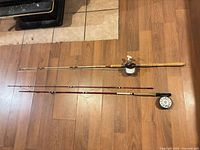 Two complete rod and reel combinations laid full length on floor for overall view