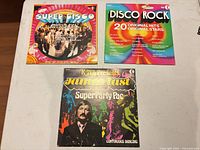 All three LP covers on table