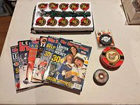 All items overview: magazines, string lights in tray, three pucks/tin