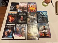 Front view of 11 visible movie cases arranged on table
