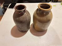 Side view of both crocks showing glaze colors and overall shape