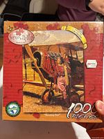 Front of shrink-wrapped Serendipity 1000-piece puzzle box showing artwork and title