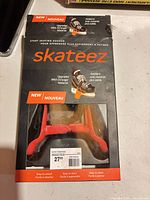 Front of Skateez box showing product name and window displaying red trainers