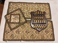 Entire lot with plaque, spoons, and three tapestry mats